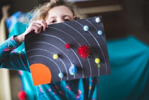 Little Girl and her solar system art project