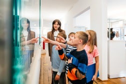 Kids Looking At Objects On Display In Museum