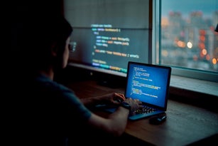 Developer working with AI code security at night
