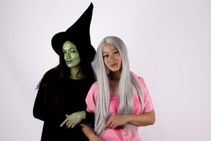 women dressed as witches, wearing a witch hat