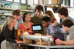 Students performing science experiment in lab