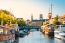 Moored boats along a narrow canal in Copenhagen old town, Denmark